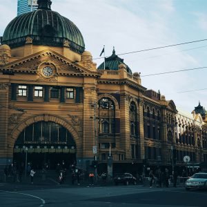 brown building with cars passing infront