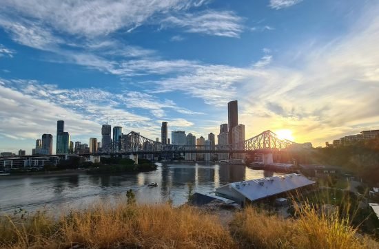 city skyline under blue sky and white clouds during daytime