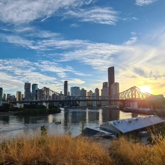 city skyline under blue sky and white clouds during daytime